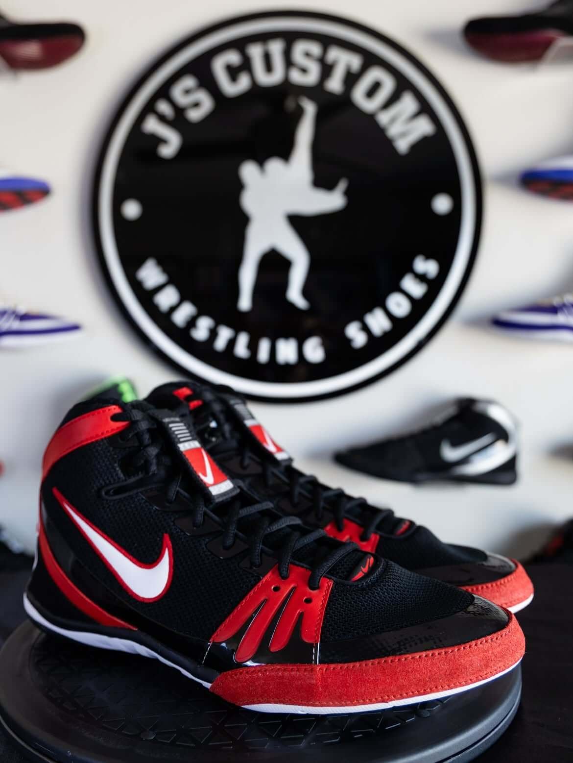 Custom hand-painted wrestling shoes in black and orange colorway